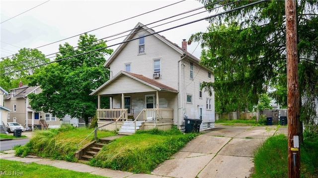 1197 Carey Ave, Akron, OH 44314 - american foursquare style home with covered porch, a chimney, and concrete driveway