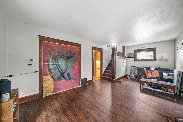 1197 Carey Ave, Akron, OH 44314 - foyer entrance with wood finished floors, stairs, a textured ceiling, and baseboards