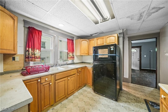 1197 Carey Ave, Akron, OH 44314 - kitchen with freestanding refrigerator, a paneled ceiling, a sink, light floors, and light countertops