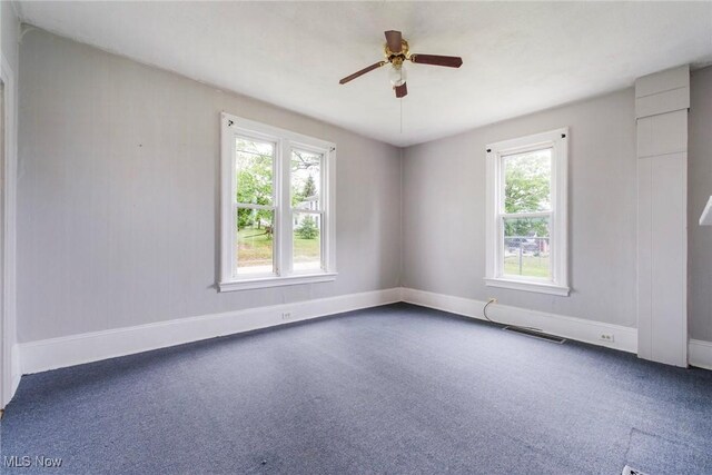 492 W Pershing St, Salem, OH 44460 - unfurnished room featuring healthy amount of natural light, ceiling fan, baseboards, and carpet