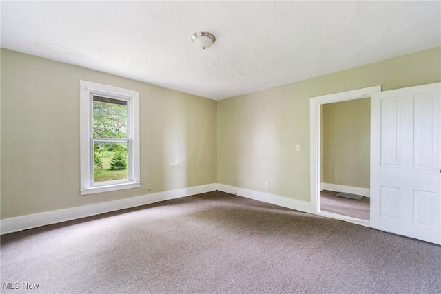 492 W Pershing St, Salem, OH 44460 - unfurnished room with dark colored carpet and baseboards