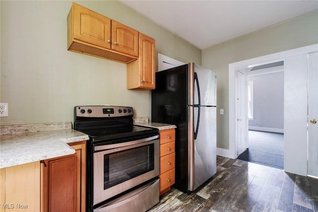 492 W Pershing St, Salem, OH 44460 - kitchen with stainless steel appliances, light countertops, dark wood-style floors, and baseboards