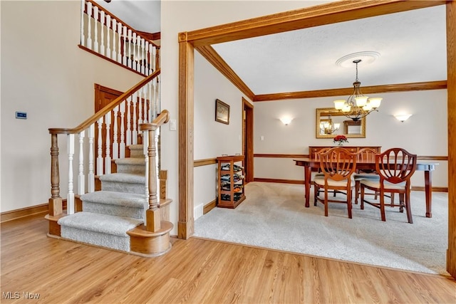 1271 Emerald Creek Dr, Broadview Heights, OH 44147 - dining space featuring a chandelier, ornamental molding, stairway, baseboards, and wood finished floors