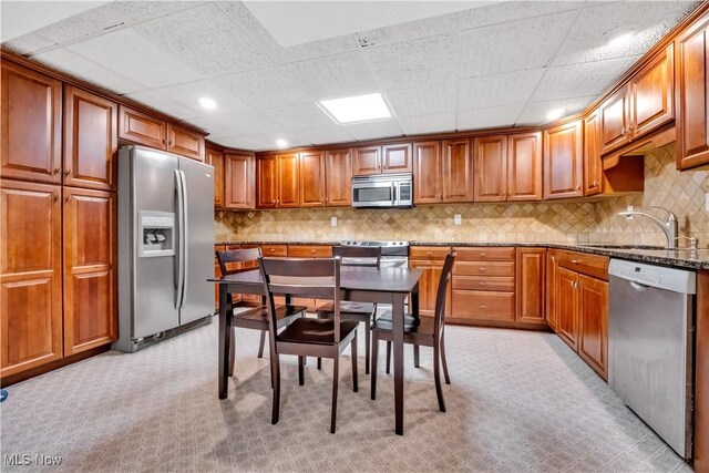 1271 Emerald Creek Dr, Broadview Heights, OH 44147 - kitchen featuring stainless steel appliances, light carpet, a sink, brown cabinetry, and recessed lighting