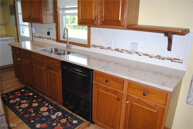 13350 Baumhart Rd, Amherst, OH 44001 - kitchen with black dishwasher, a sink, backsplash, and light stone countertops