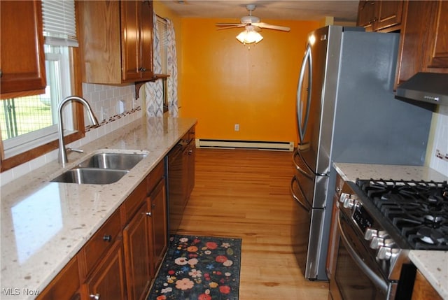 13350 Baumhart Rd, Amherst, OH 44001 - kitchen featuring a baseboard heating unit, light wood-type flooring, a sink, ventilation hood, and tasteful backsplash