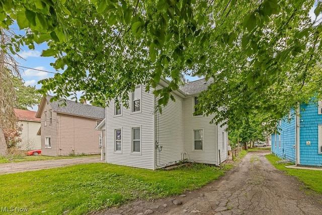 319 Sterling Ct, Akron, OH 44304 - view of front of house with asphalt driveway and a front lawn