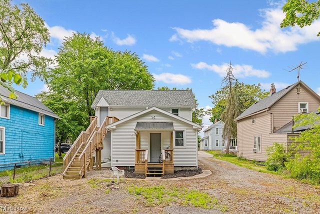 319 Sterling Ct, Akron, OH 44304 - view of front facade with stairs, dirt driveway, and a shingled roof