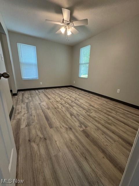 319 Sterling Ct, Akron, OH 44304 - unfurnished room with wood finished floors and ceiling fan