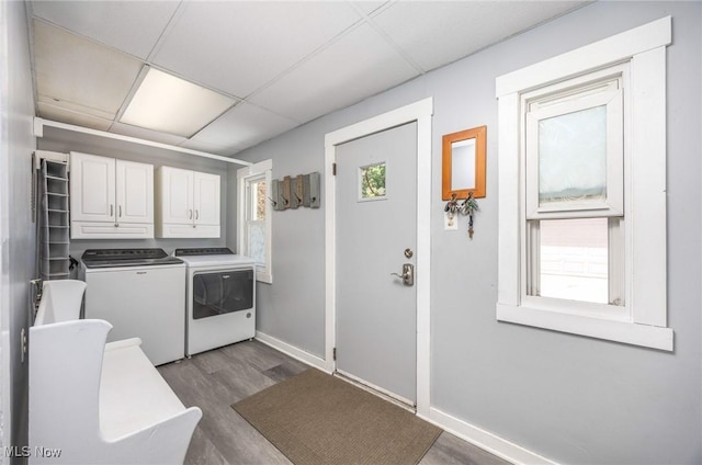 201 E Spring St, Marietta, OH 45750 - laundry area featuring cabinet space, washing machine and dryer, dark wood-style floors, and baseboards