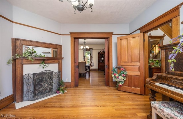 201 E Spring St, Marietta, OH 45750 - foyer featuring a chandelier and light wood-style floors