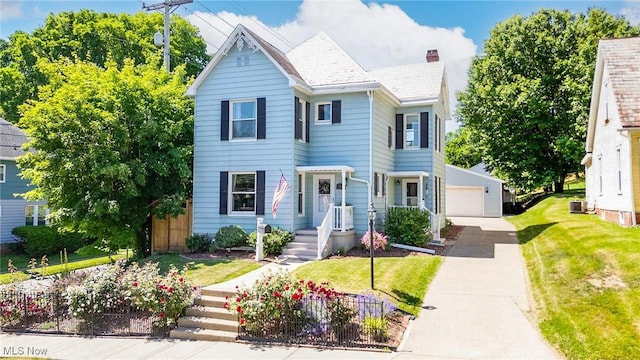 201 E Spring St, Marietta, OH 45750 - view of front of home with central AC unit, a garage, and a chimney