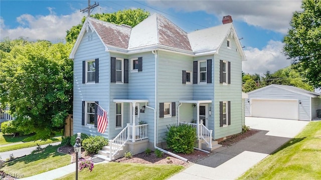 201 E Spring St, Marietta, OH 45750 - view of front facade featuring an outdoor structure, a detached garage, a chimney, and a front lawn