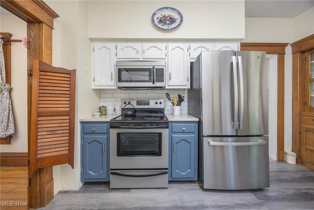 201 E Spring St, Marietta, OH 45750 - kitchen featuring stainless steel appliances, wood finished floors, white cabinets, and decorative backsplash