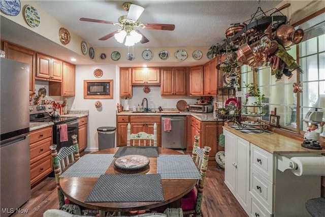 3490 Vanderhoof Rd, New Franklin, OH 44203 - kitchen featuring appliances with stainless steel finishes, a ceiling fan, dark wood-type flooring, light countertops, and a sink