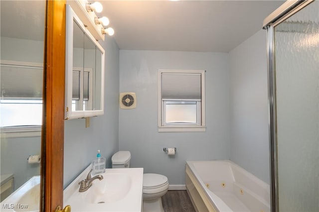 7084 Germano SE, Carrollton, OH 44615 - bathroom with toilet, a jetted tub, a sink, wood finished floors, and baseboards