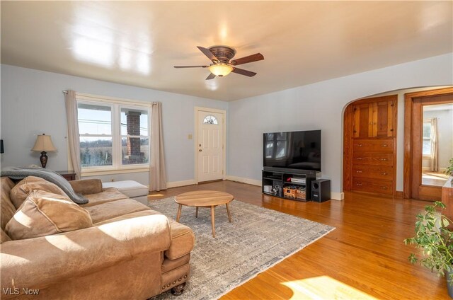 7084 Germano SE, Carrollton, OH 44615 - living area featuring ceiling fan, wood finished floors, arched walkways, and baseboards