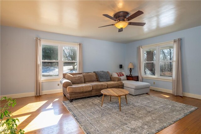 7084 Germano SE, Carrollton, OH 44615 - living area with wood finished floors, baseboards, and a ceiling fan
