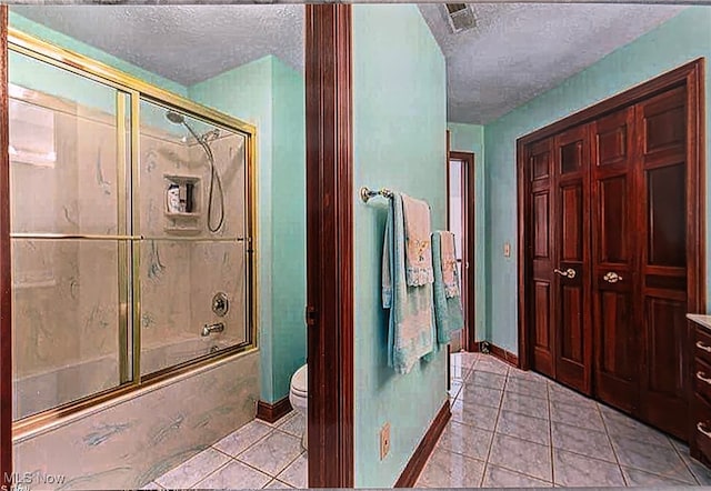 6419 S Rim Cir, Valley City, OH 44280 - full bath featuring a textured ceiling, bath / shower combo with glass door, tile patterned floors, toilet, and baseboards