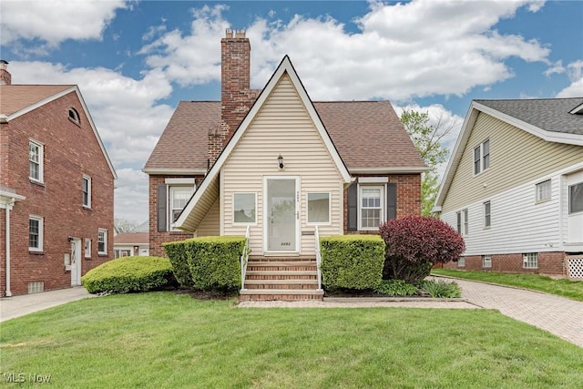 3493 W 146th St, Cleveland, OH 44111 - view of front of house with a chimney, a front yard, and brick siding