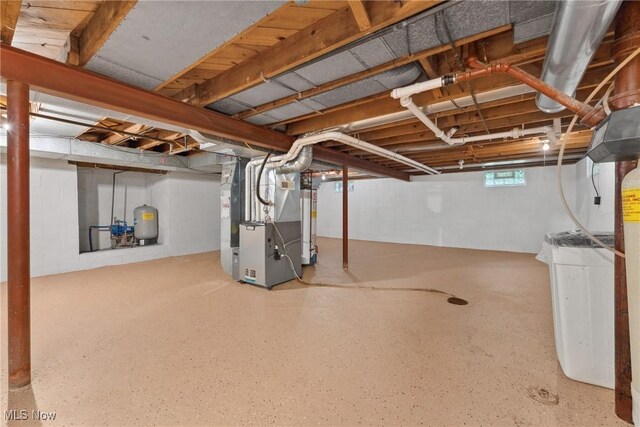 6525 Wales Ave NW, Massillon, OH 44646 - below grade area featuring heating unit and a water pressure tank
