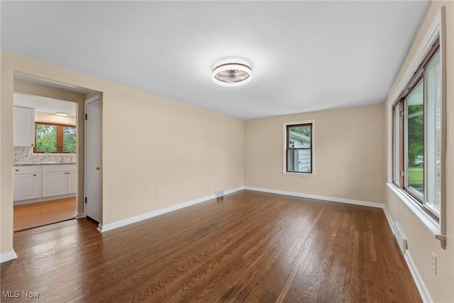 6525 Wales Ave NW, Massillon, OH 44646 - unfurnished room featuring dark wood finished floors and baseboards