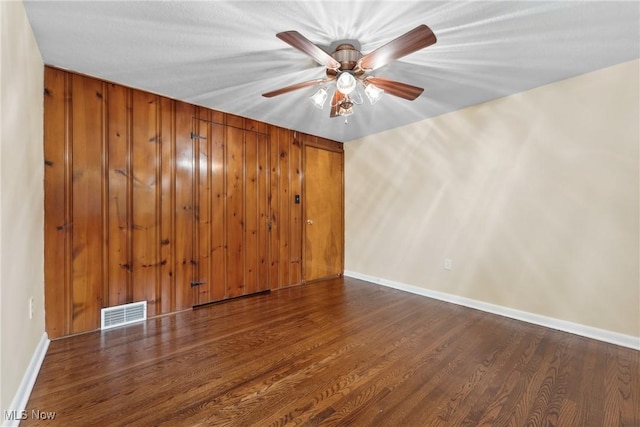 6525 Wales Ave NW, Massillon, OH 44646 - unfurnished room featuring wood finished floors, a ceiling fan, and baseboards
