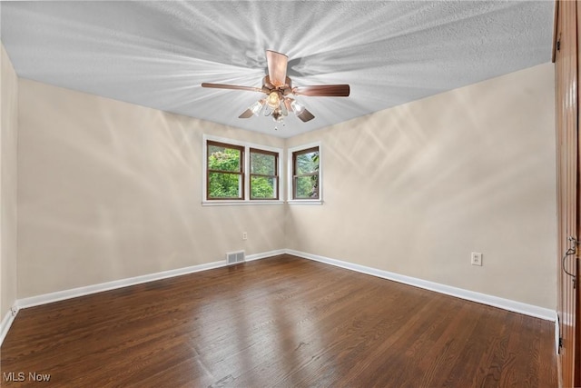 6525 Wales Ave NW, Massillon, OH 44646 - empty room featuring dark wood finished floors, ceiling fan, and baseboards