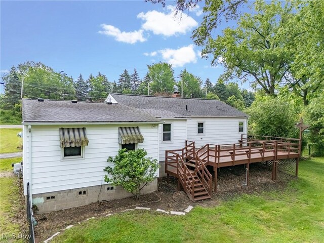 6525 Wales Ave NW, Massillon, OH 44646 - rear view of house with a deck, roof with shingles, and a yard
