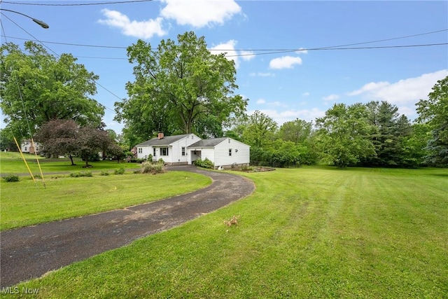6525 Wales Ave NW, Massillon, OH 44646 - view of green lawn featuring asphalt driveway