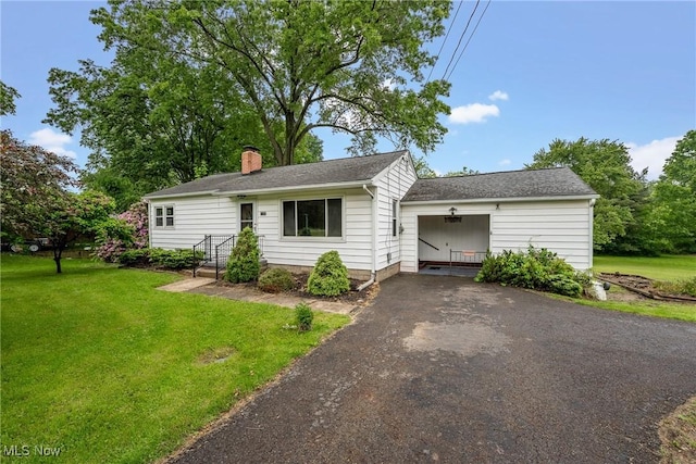 6525 Wales Ave NW, Massillon, OH 44646 - ranch-style house with a front lawn, asphalt driveway, a chimney, a garage, and roof with shingles