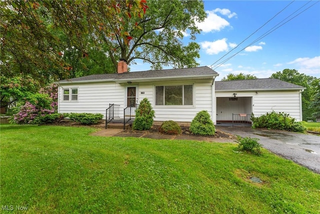 6525 Wales Ave NW, Massillon, OH 44646 - ranch-style home with asphalt driveway, a front yard, a chimney, and a carport