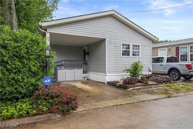 6610 Lear Nagle Rd Unit 26, North Ridgeville, OH 44039 - view of side of home with concrete driveway and an attached carport
