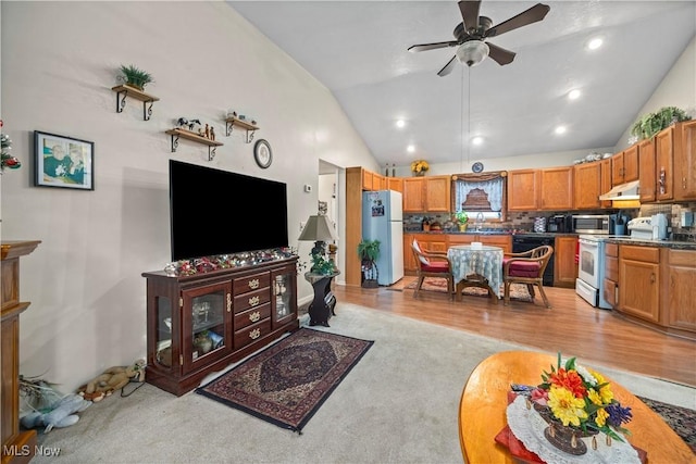 6610 Lear Nagle Rd Unit 26, North Ridgeville, OH 44039 - living room featuring a ceiling fan, light colored carpet, and high vaulted ceiling