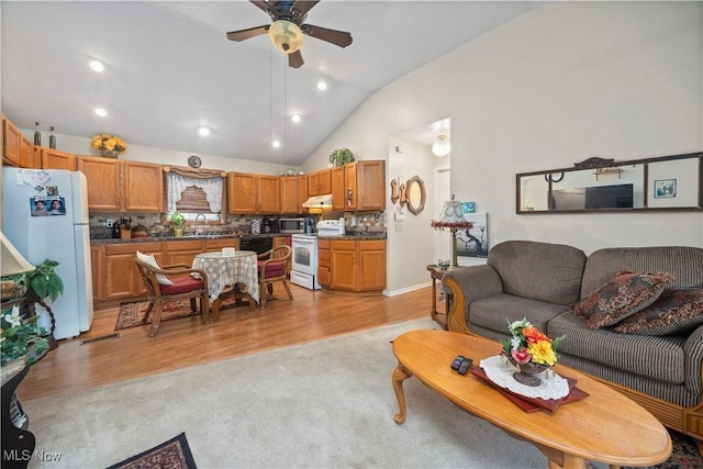 6610 Lear Nagle Rd Unit 26, North Ridgeville, OH 44039 - living room featuring a ceiling fan, lofted ceiling, recessed lighting, light colored carpet, and light wood-type flooring