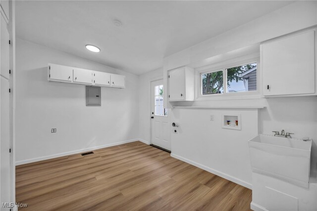 6482 Sherborn Rd, Parma Heights, OH 44130 - washroom featuring electric panel, light wood finished floors, washer hookup, and baseboards