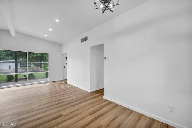 6482 Sherborn Rd, Parma Heights, OH 44130 - spare room with vaulted ceiling, a chandelier, baseboards, wood finished floors, and recessed lighting