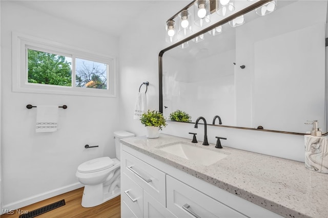 6482 Sherborn Rd, Parma Heights, OH 44130 - bathroom with vanity, toilet, wood finished floors, baseboards, and a shower