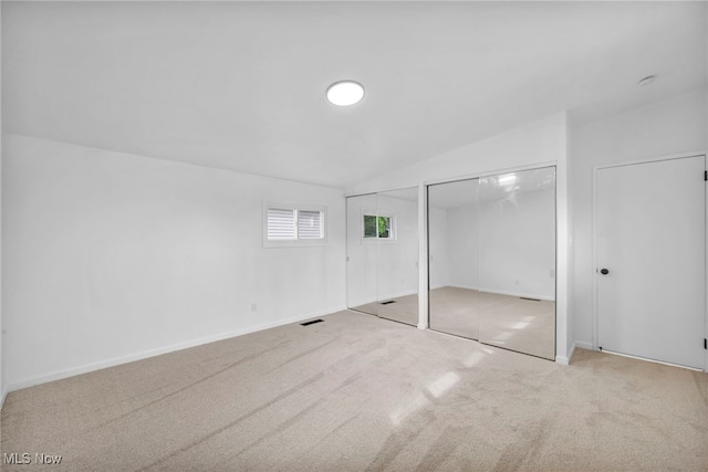 6482 Sherborn Rd, Parma Heights, OH 44130 - unfurnished bedroom with multiple closets, carpet flooring, vaulted ceiling, and baseboards