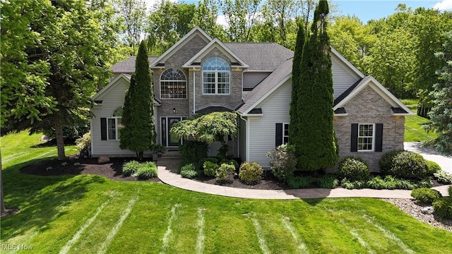 3130 Hollybrook Ln, Mogadore, OH 44260 - view of front facade featuring a front lawn and brick siding