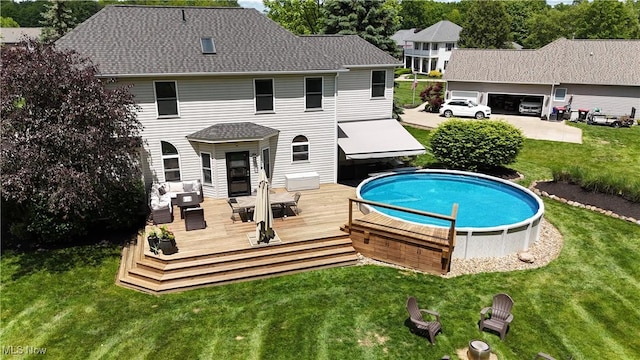 3130 Hollybrook Ln, Mogadore, OH 44260 - rear view of house with a deck, a yard, an outdoor pool, and a shingled roof