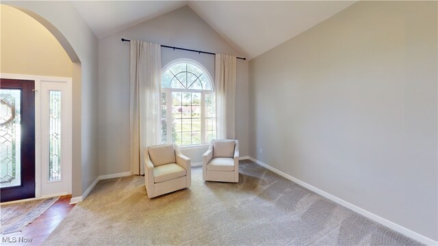 3130 Hollybrook Ln, Mogadore, OH 44260 - foyer entrance featuring arched walkways, vaulted ceiling, baseboards, and carpet flooring