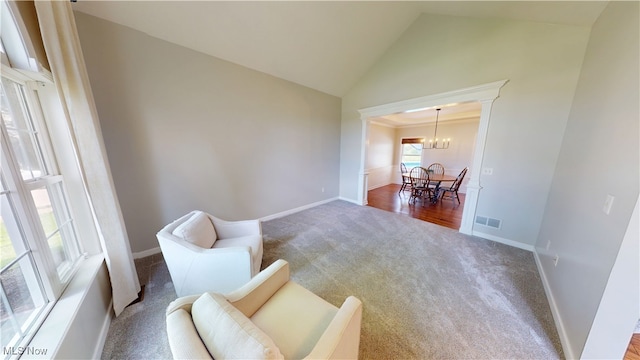 3130 Hollybrook Ln, Mogadore, OH 44260 - sitting room featuring carpet, a chandelier, baseboards, and high vaulted ceiling