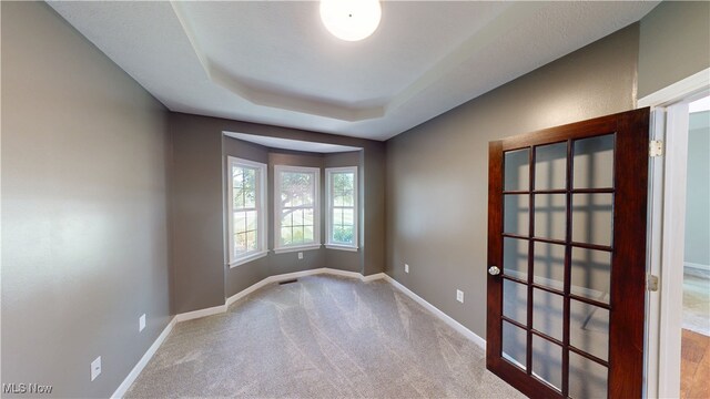 3130 Hollybrook Ln, Mogadore, OH 44260 - empty room with baseboards, carpet floors, and a tray ceiling