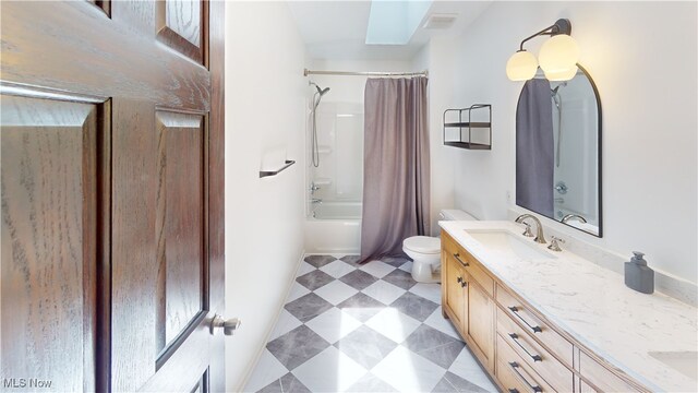 3130 Hollybrook Ln, Mogadore, OH 44260 - full bathroom featuring double vanity, toilet, tile patterned floors, a skylight, and shower / tub combo with curtain
