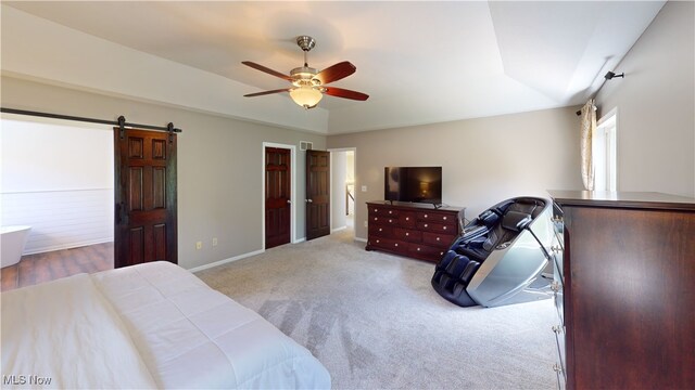 3130 Hollybrook Ln, Mogadore, OH 44260 - carpeted bedroom with a barn door, ceiling fan, and baseboards