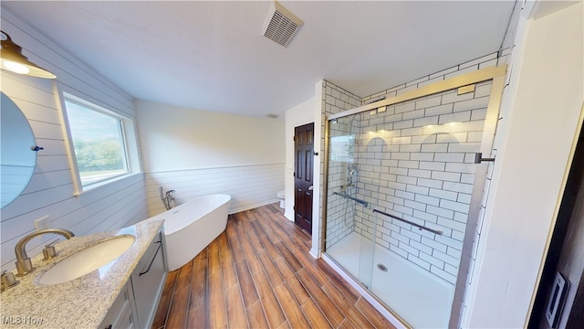 3130 Hollybrook Ln, Mogadore, OH 44260 - full bathroom with vanity, a stall shower, a soaking tub, toilet, and wood walls