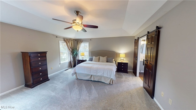 3130 Hollybrook Ln, Mogadore, OH 44260 - bedroom featuring a barn door, baseboards, light carpet, and a ceiling fan