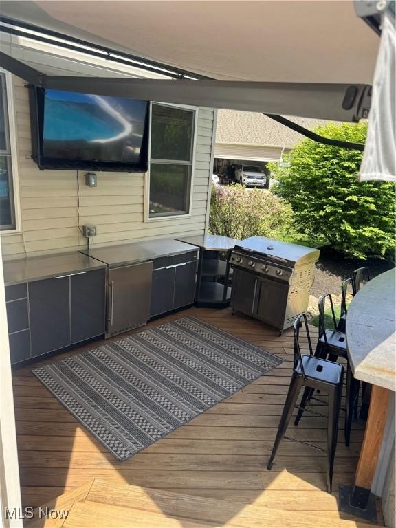 3130 Hollybrook Ln, Mogadore, OH 44260 - wooden terrace with area for grilling and outdoor dining space