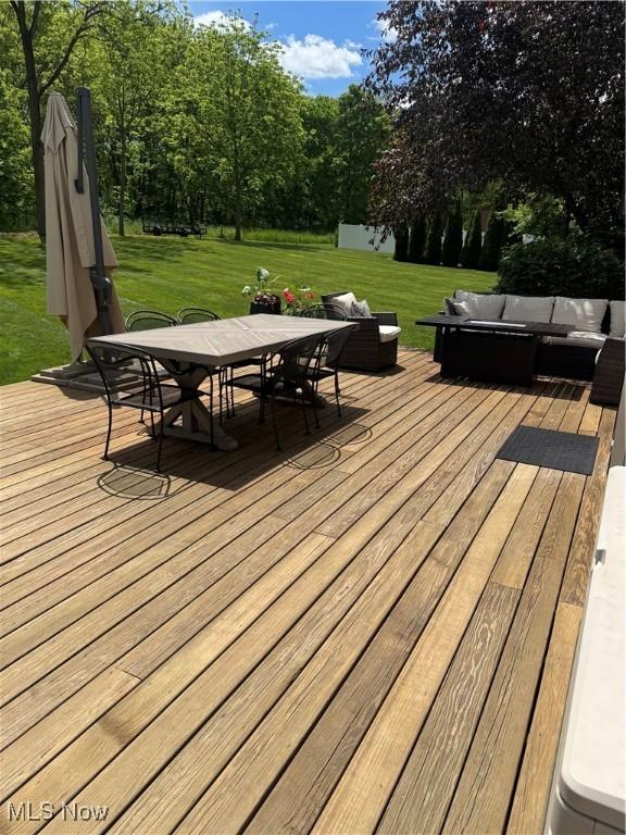3130 Hollybrook Ln, Mogadore, OH 44260 - deck with an outdoor living space, outdoor dining space, a yard, and view of scattered trees
